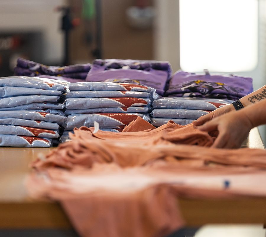 closeup of person folding shirts