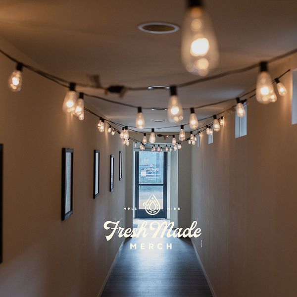 View of empty hallway with string lights on ceiling